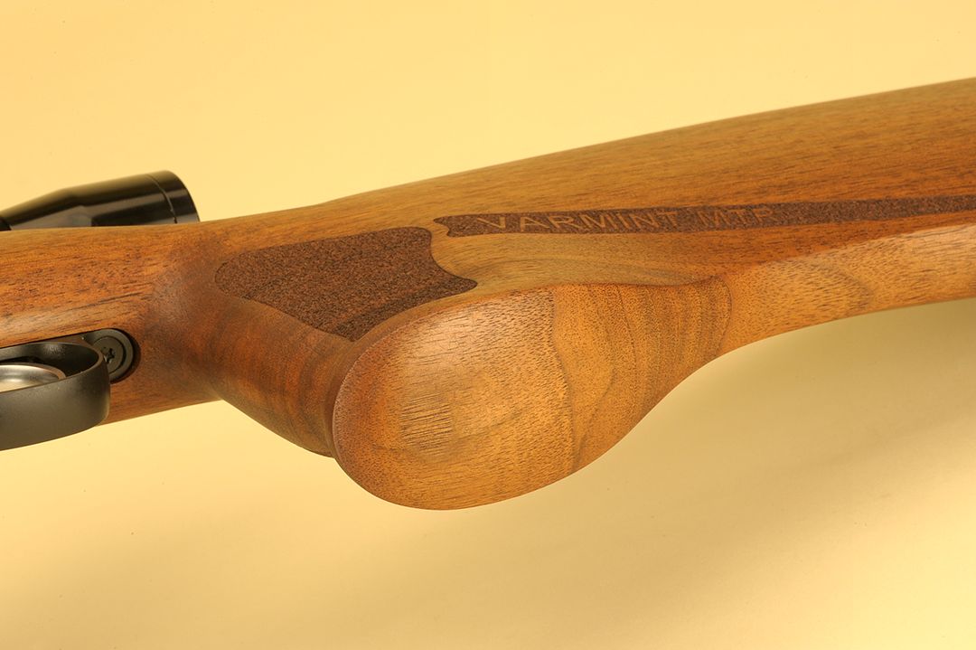 There is no grip cap on the pistol grip and in looking at the photo, it can be seen why it would be very difficult to make or install. Behind the grip, the stock flattens out to aid as a better resting place for benchrest shooting.